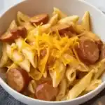 Delicious cheesy sausage pasta with rich sauce and melted cheese, perfect for quick dinner.